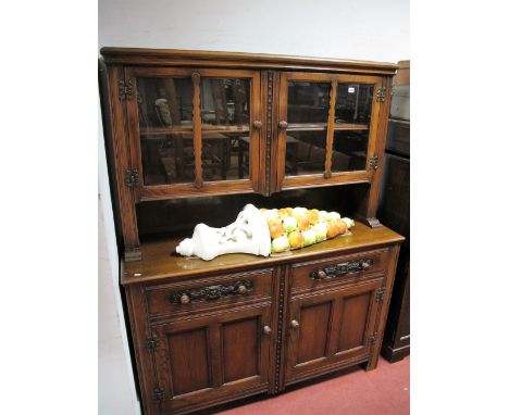 XX Century Oak Dresser, the top with glazed doors, internal shelf, base with two small drawers, over panelled cupboard doors,