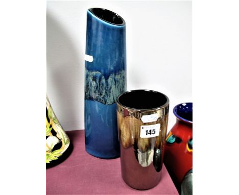 A Poole Pottery Elliptical Vase, having streaked band on blue ground, 33cms high, another cylindrical in brown lustre. (2) 