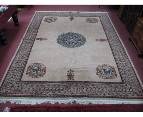 A Wool Tassled Carpet, with symmetrical centre motifs, vase and animal designs to border on beige ground, 370 x 305cms approx