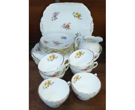 A Coalport Sevres six setting embossed tea service decorated with flowers 
