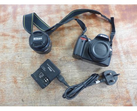 A Nikon D60 10.2mp digital camera with Nikkon Nikkor 35-80mm f1.4-5.6d lens, Nikon strap, battery charger and carry bag