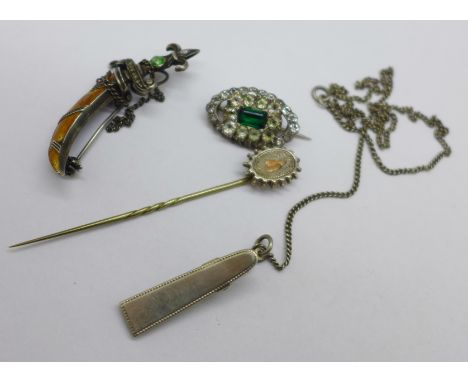 Jewellery; an enamelled dagger brooch, one other brooch, a pin and a clip, test as silver, the clip marked 835 