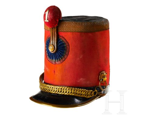 A shako for French cavalry officer  Cap body in red cloth, black oil cloth top, cap band of black leather with semi-circular 