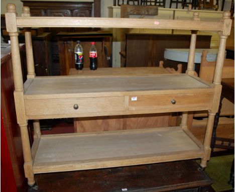 A contemporary light oak three tier buffet having twin central drawers