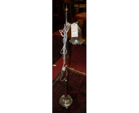 An Art Nouveau polished steel standard lamp, having a revolving action *** AND A BRASS SPARK GUARD ***