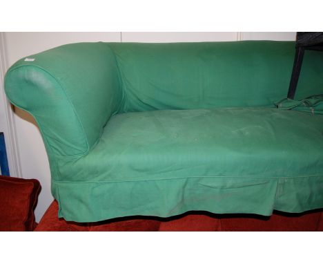 A late Victorian upholstered three seater sofa, raised on turned walnut bun forelegs