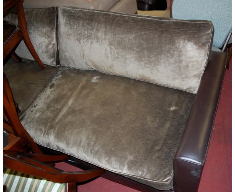 A modern chocolate brown leather and plush cushion upholstered four seater sofa 