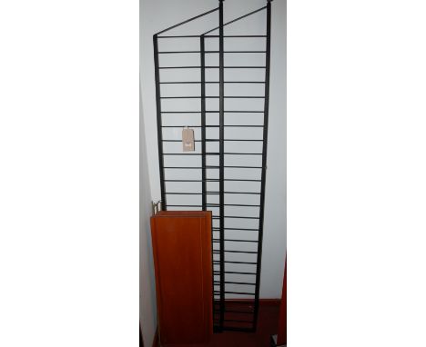A 1970s Ladderax open shelving unit comprising a pair of black metal side rails, four shelves, and further metal shelf suppor