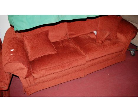 A modern red upholstered two piece suite, comprising three seater sofa and armchair