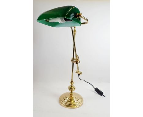 A brass adjustable desk lamp wtih green glass shade 