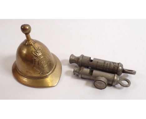 An EMCA Boy Scout whistle, a Metropolitan Hudson Police whistle and a fireman's helmet for novelty brass bell 