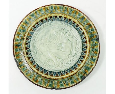 A Doulton Lambeth stoneware plate decorated nude, damaged 