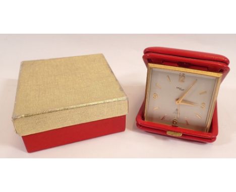 An Imhof red leather cased travel alarm clock, boxed with receipt 