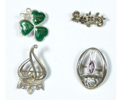 An Irish silver and enamel Shamrock brooch and three other brooches