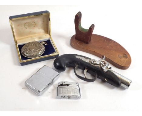 Three lighters including novelty gun lighter, Zippo and Brother-lite plus a vesta case &amp; wooden stand 