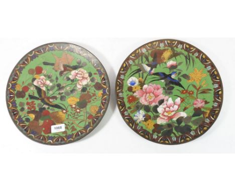 A pair of Japanese Meiji period cloisonné enamel plates decorated birds and flowers, 30cm diameter 