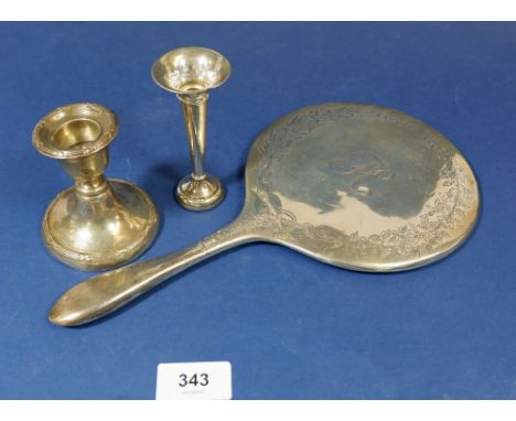 A silver candlestick, silver bud vase and silver hand mirror frame (glass missing) 