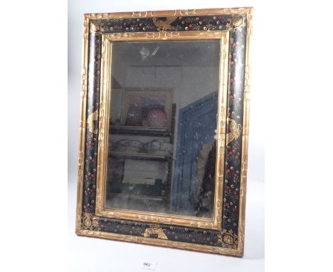 A late 19th century gilt and black framed easel mirror with carved laurel leaf borders and painted bird and flower decoration