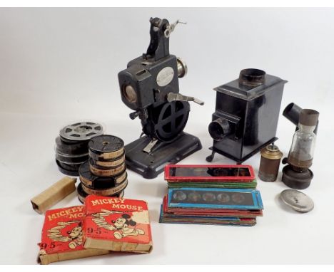 A Pathe Kid 9.5mm cine projector and various reels of film, some cased plus a childs oil toy projector and slides 