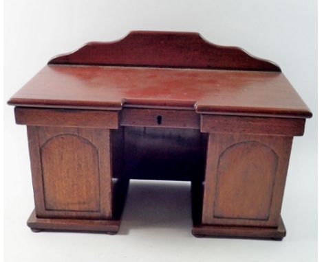 A 19th century mahogany apprentice piece or tea caddy in the form of a twin pedestal sideboard, each sliding out to reveal th
