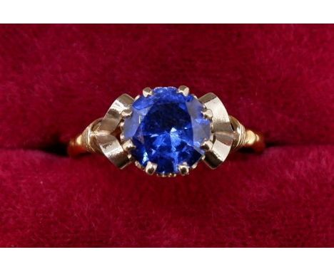 A single stone sapphire ring of good colour, approx 1.5cts, in yellow and white gold scroll setting, marked to shank 9 carat 