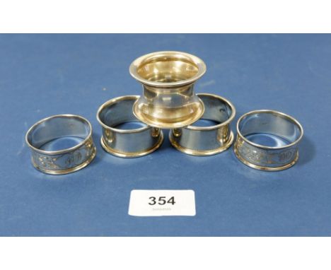 Two pairs of silver napkin rings, Chester 1902 and London 1915 plus one other napkin ring, 52g 