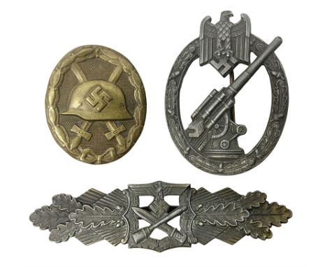 Three WW2 German badges - Close Combat Clasp; Army Flak badge; and Wound badgeCondition Report:Close Combat badge lacking bac
