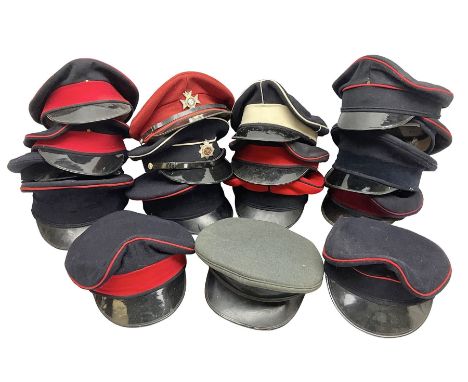 Seventeen regimental and corps head-dress, predominantly without cap badges, but two with Light Dragoons and Royal Corps of T