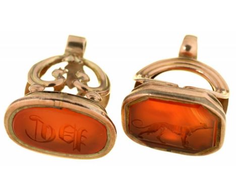 TWO CARNELIAN FOB SEALS, ONE WITH A GREYHOUND CREST, THE OTHER MONOGRAMMED, IN GOLD, 21G++LIGHT WEAR CONSISTENT WITH AGE