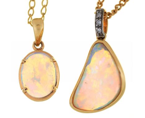A FREEFORM SHAPED OPAL PENDANT OF 2.5 CT APPROX, IN DIAMOND SET GOLD MOUNT, MARKED 14k, ON 9CT GOLD CHAIN AND AN OVAL CABOCHO