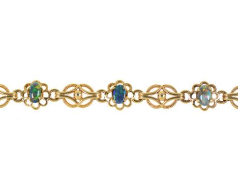 AN AUSTRALIAN BLACK OPAL BRACELET, THE SEVEN BLACK OPALS OF VARYING HUES, 3 CT APPROX TOTAL, IN GOLD MARKED 9KT, 10.5G++OPALS