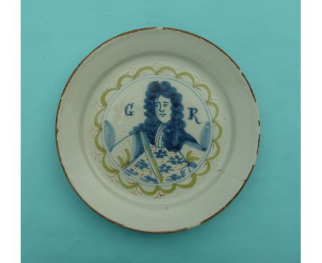George I: an English (probably Bristol) Delft plate painted in blue, green and orange with a half-length portrait initialled 