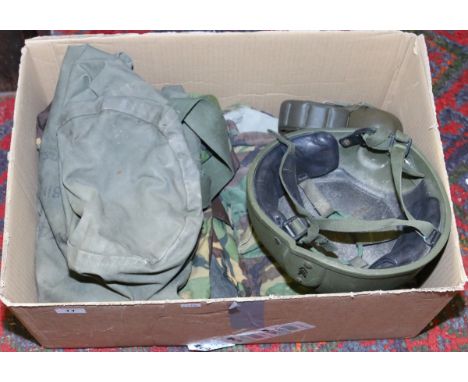 A collection of military items to include helmet, kit bag and clothing, etc.