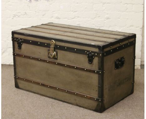 A vintage canvas and wood bound steamer trunk, Louis Vuitton label to the inside.