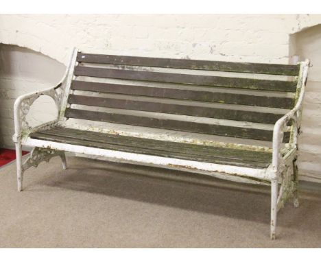 A Victorian Christopher Dresser style large painted iron bench with wooden slats.
