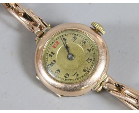 A ladies vintage 9ct rose gold manual wristwatch on gold plated bracelet strap.