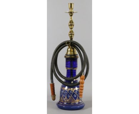 A Middle Eastern glass hookah pipe.