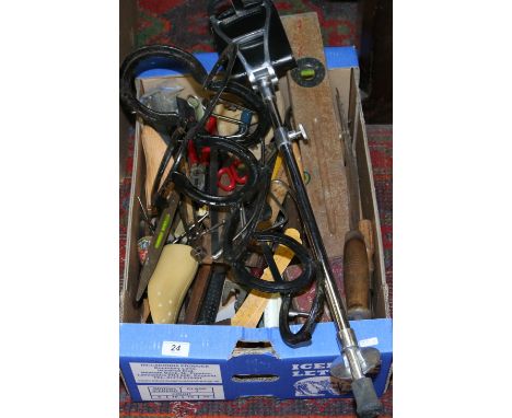 A box of assorted old tools along with a shooting stick and horse shoe wall mounting plantstand.