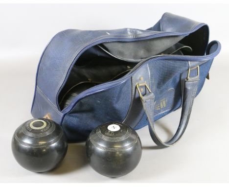 A bowling bag and contents of two sets of bowls: one set of four Greenmaster size 2, the other a set of Rinkmaster R G Lawrie