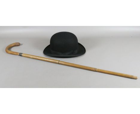 A metamorphic walking stick with concealed umbrella along with a gentleman's bowler hat by Christies of London.