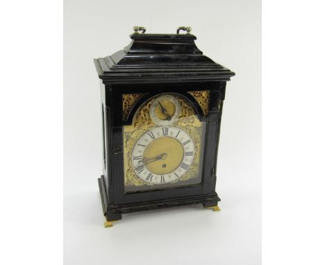 A Georgian style ebonised bracket clock, brass break arch dial with cherub's head spandrels, silvered chapter ring bearing Ro