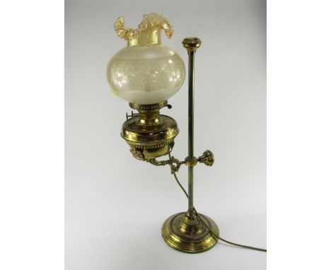 A brass adjustable oil lamp, converted to electricity, with an etched glass shade, 69cm high.