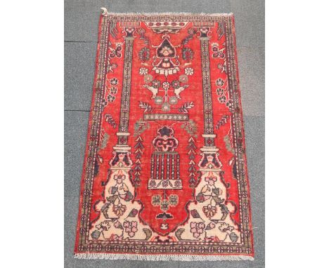 A Tabriz prayer rug, decorated with vases of flowers and birds within a column arch, 155cm x 87cm.