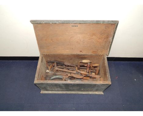 A tool chest containing planes, braces and other carpentry tools.