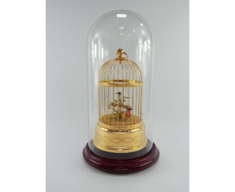 A Sainte Croix Reuge Music bird cage automaton, under a glass dome.