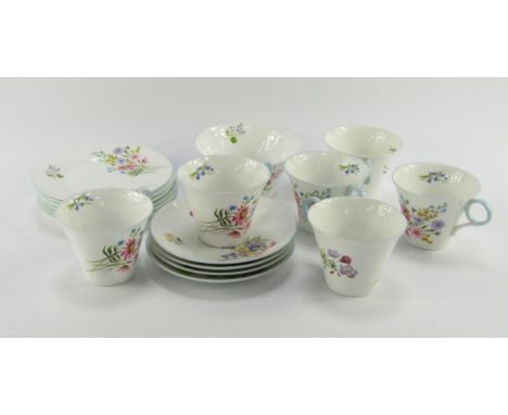 A Shelley porcelain part tea service decorated in the Wild Flowers pattern, 13668, comprising sugar bowl, five cups, four sau