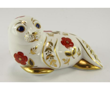 A Royal Crown Derby porcelain Imari paperweight modelled as a seal, gold button.