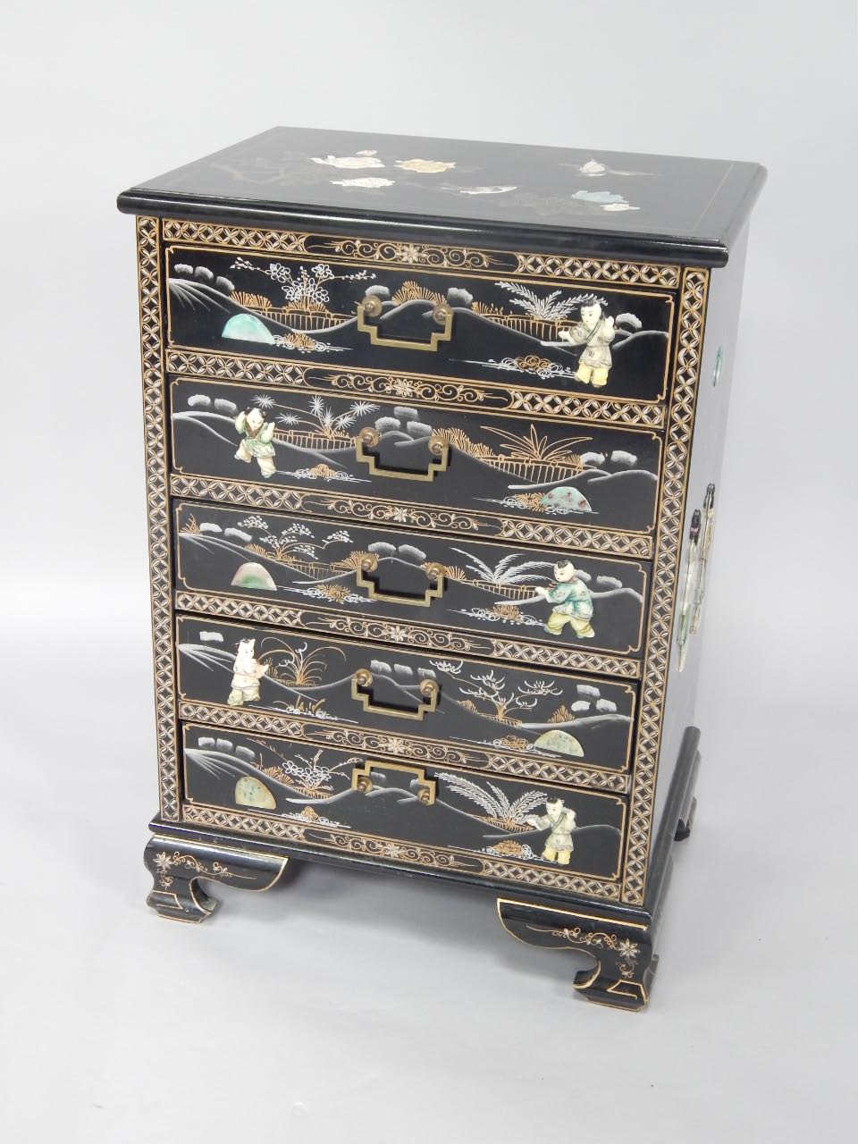 A Chinese painted black lacquer chest of drawers, five drawers with