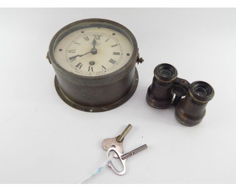 A WWII Smiths destroyer bulkhead time switch clock, 1943, serial no Sec269, with keys, together with a pair of field glasses.