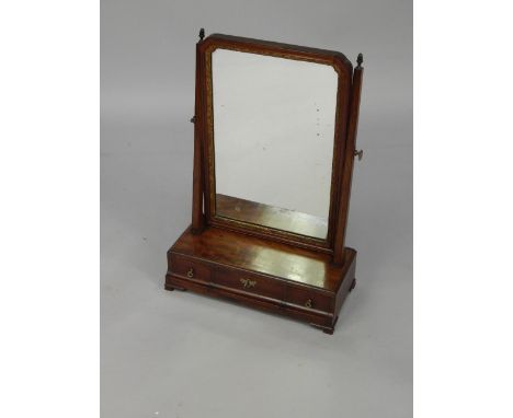 A George II style mahogany swing frame toilet mirror, with three cushion drawers, raised on ogee bracket feet, 43cm x 20cm x 